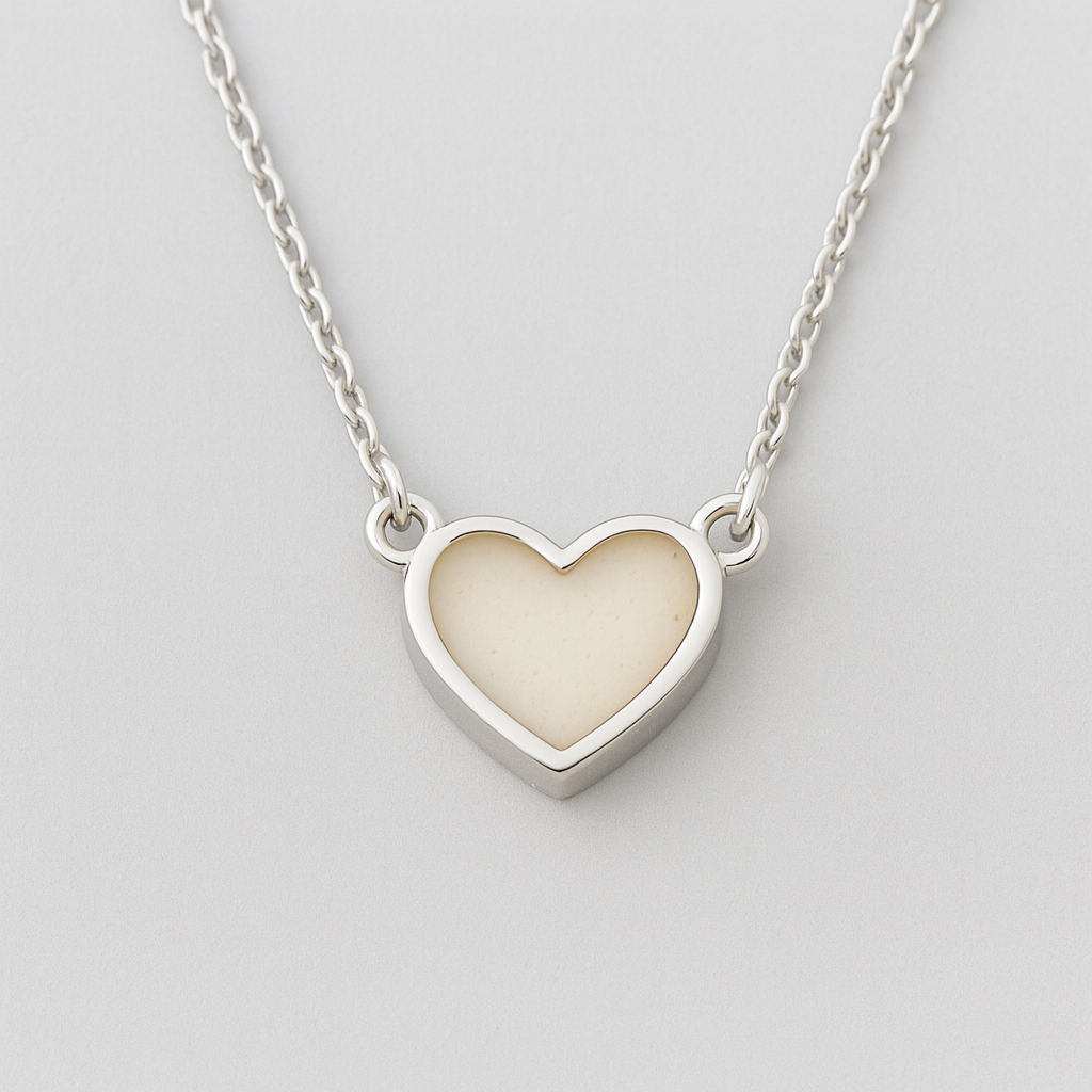 Sterling silver heart breastmilk necklace with natural creamy resin keepsake.